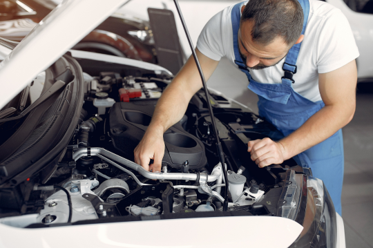 Mecánico haciendo un mantenimiento del coche